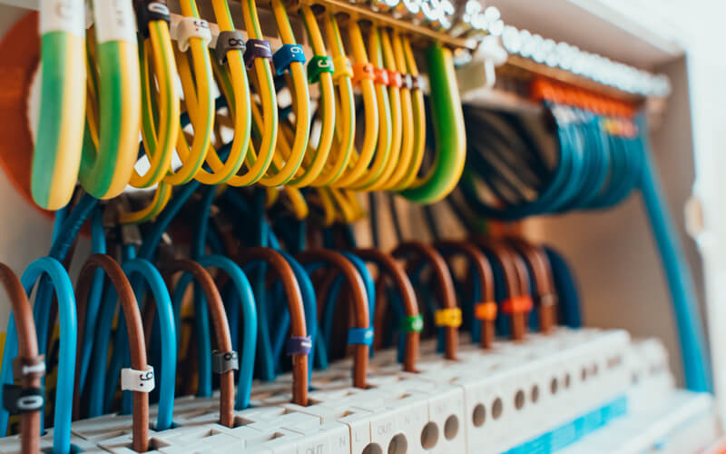 Electrician inspecting wiring in an older London home during a house rewire